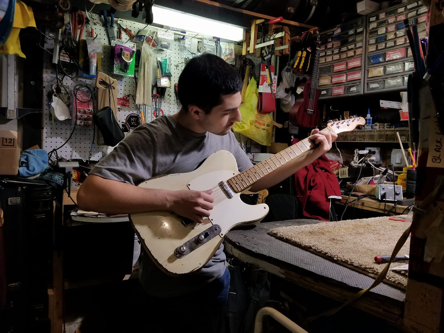 Photo of Dean Gordon repairing 1950s era telecaster at Chelsea Guitars NYC. 