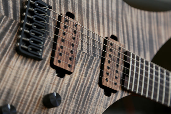 Closeup photo of a Dean Gordon Guitars Virtus flat top 7 string with flame maple top.